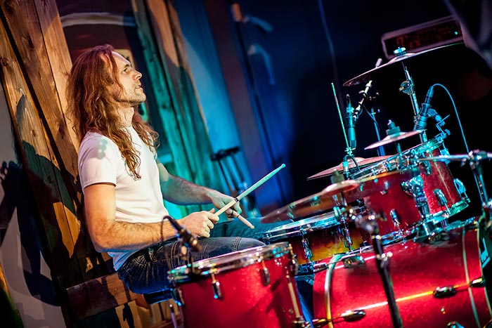 Long hair drummer performing on stage