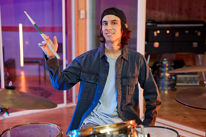 Drummer holding drum stick in the air